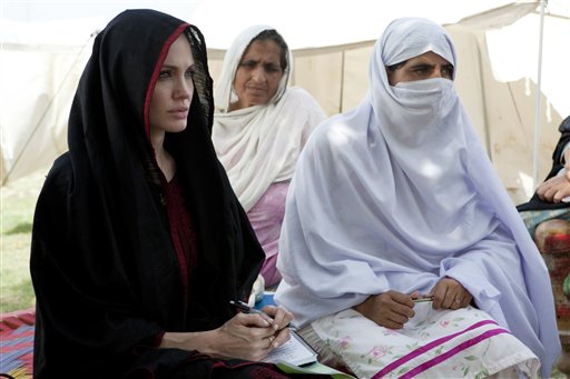 In this photo provided by the United Nations High Commission for Refugees, Angelina Jolie, left, the goodwill ambassador of UNHCR, sits with Pakistani flood affected women during her visit to a camp for people displaced by heavy floods in Nowshera, Pakistan, Tuesday, Sept. 7, 2010. (AP Photo/United Nations High Commission for Refugees, J. Tanner)