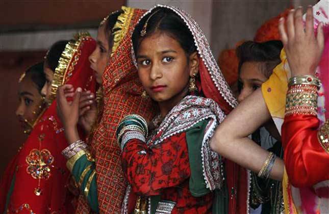 'Unity in diversity', rightly proven today when the country is enjoying the flavors of various regional festivals. Indian girls dressed in traditional attire watch a cultural performance as they celebrate Lohri festival. (AP Photo)