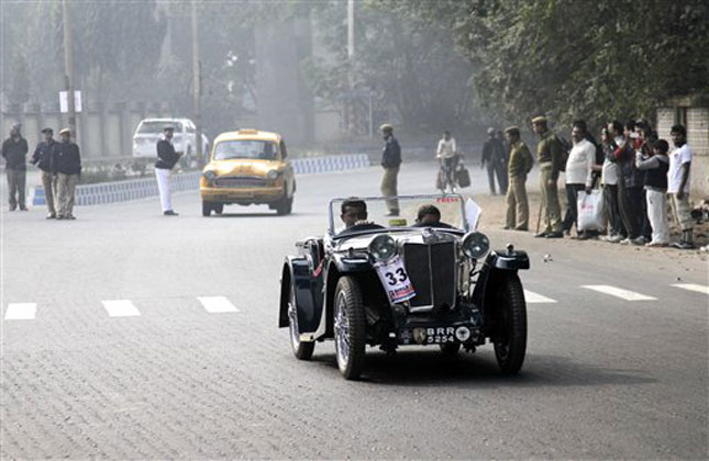 Some people love to own and flaunt vintage items. Fore such vintage lovers a car rally was organized in Kolkata where this man drives a ten horsepower four cylinder 1933 MG PA car. (AP Photo)