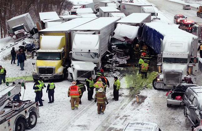 Emergency crews work at the scene of a massive pileup involving more than 40 vehicles, many of them semitrailers, along Interstate 94 Thursday afternoon, Jan. (AP Photo)