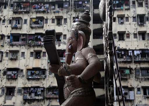 Devotees carry a huge idol of Lord Ganesha Hindu god Ganesha, backdropped by high rise buildings ahead of Ganesha Chaturti festival in Mumbai, India, Thursday, Sept. 9, 2010. Every year millions of devout Hindus immerse idols of god Ganesh into oceans and rivers in the ten day long Ganesh Chaturti festival that celebrates the birth of the Hindu god. (AP Photo/Rajanish Kakade)