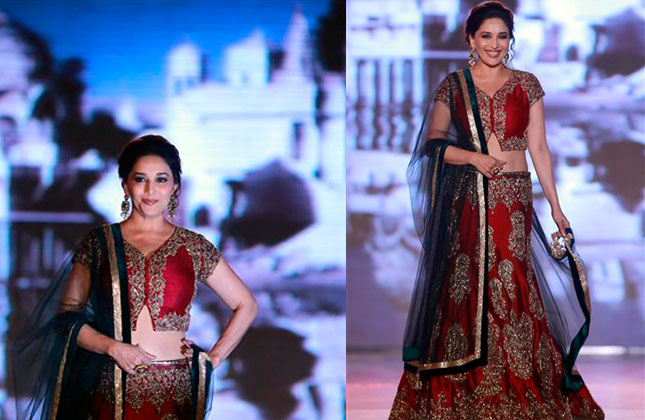 Bollywood actress Madhuri Dixit displays an outfit by Indian designer Manish Malhotra during a fashion show to support the cause of saving and empowering the female child in Mumbai. (AP Photo)