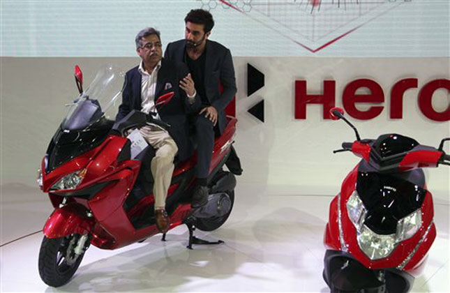 Hero Motors Corporation Limited's Managing Director and CEO Pawan Munjal with Bollywood actor Ranbir Kapoor pose with Hero motorbikes during their unveiling at the 12th Indian auto Expo in Noida. (AP Photo)
