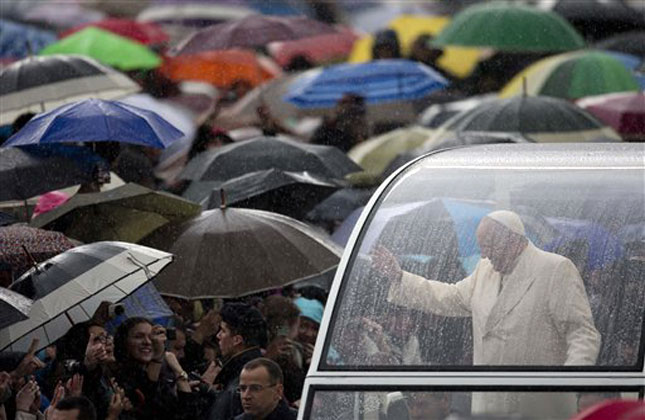 Pope Francis greets the faithful as he arrives for his weekly general audience in St. Peter's Square at the Vatican. (AP Photo)