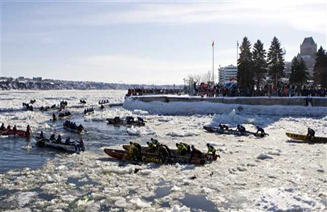 Ice canoe teams race on the icy St. Lawrence River as part of Quebec's Winter Carnival activities in Quebec City. (AP Photo)