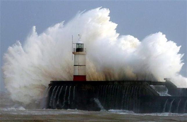 Waves crash over the harbour wall in Newhaven, southern England as large parts of Britain remain at risk of flooding as the country continues to be battered by strong winds and powerful waves. (AP Photo)