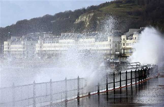 Waves crash over the promenade in Dover, southeastern as more bad weather and storms sweep across the country. (AP Photo)