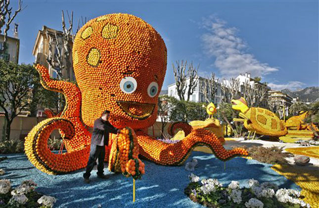 A worker sets up an octopus made with lemons and oranges during the 81st Lemon festival in Menton. (AP Photo)