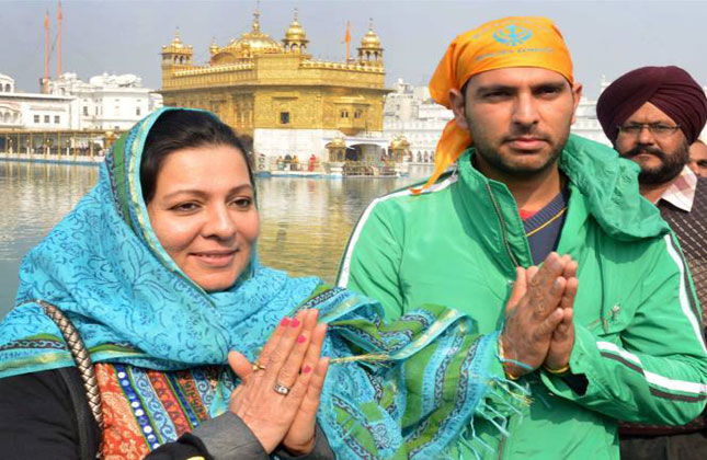 All have seen their sporty side...but here we bring to you the religious side of our cricketers. Indian international cricketer Yuvraj Singh (R) and his mother pay respects at the Sikh Shrine Golden temple in Amritsar.