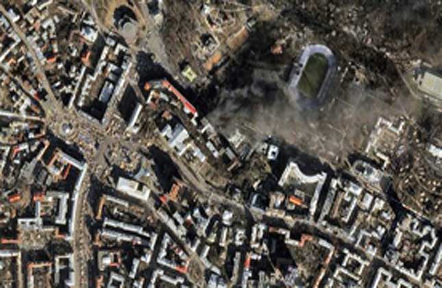 Satellite image Smoke rises from the site of anti government protests, upper center, in Kiev, Ukraine. Thousands of riot police armed with stun grenades and water cannons attacked the sprawling protest camp in the center of Kiev on Tuesday, following a day of street battles that left 18 people dead and hundreds injured. (AP Photo)