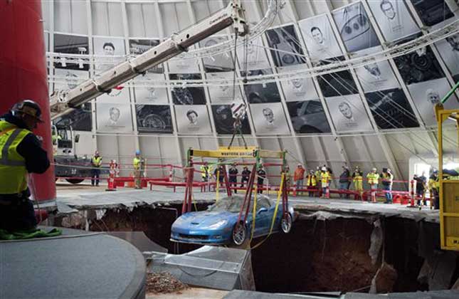One of eight Chevrolet Corvettes is removed from a sinkhole in the Skydome at the National Corvette Museum. (AP Photo)