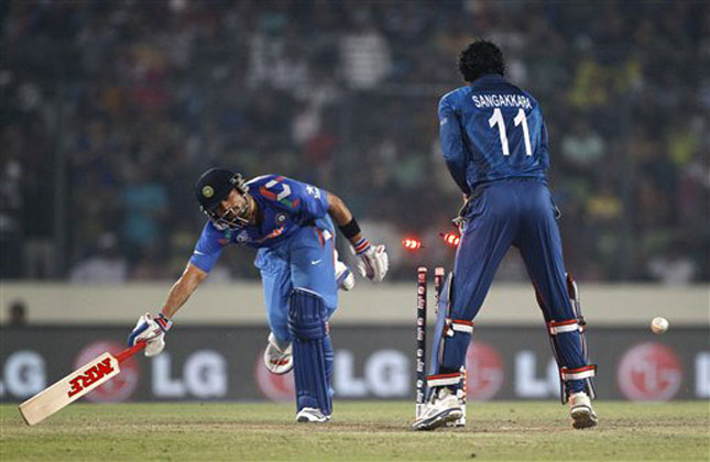 Sri Lanka's Sangakkara successfully dislodges the bails to dismiss of India's Virat Kohli, left, during their ICC Twenty20 Cricket World Cup final match in Dhaka. (AP Photo)