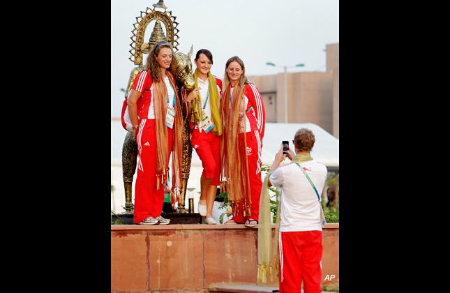 England team members pose for a photograph by a fellow team member following their flag hoisting ceremony at the Commonwealth Games athletes' village, in New Delhi, India, Friday, Oct. 1, 2010. The Commonwealth Games are scheduled to begin on Sunday. (AP Photo/Manish Swarup)