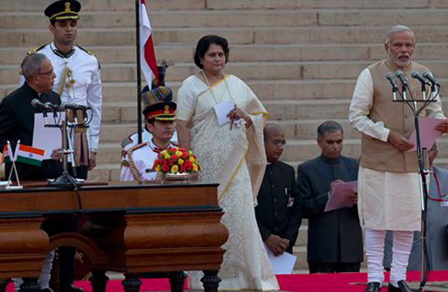 Indian President Pranab Mukherjee, left, administers the oath of office to new prime minister Narendra Modi, right, at the presidential palace in New Delhi, India, Monday, May 26, 2014. Modi's inauguration is the first to which India invited leaders from across South Asia. (AP Photo)