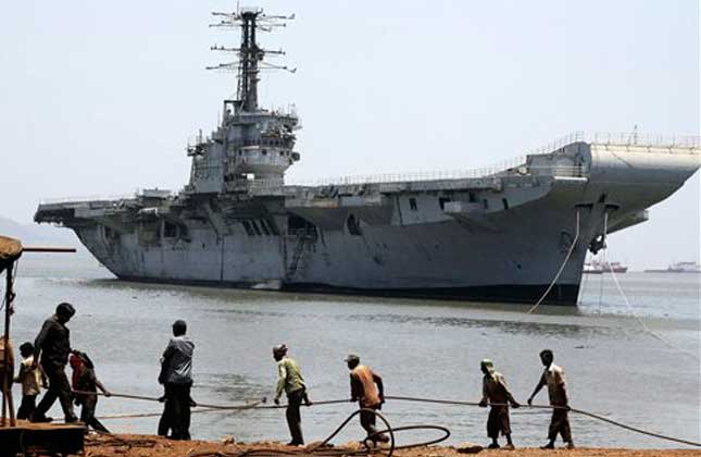 Indian navy's first aircraft carrier the INS Vikrant is drawn closer to shore at Darukhana ship breaking yard in Mumbai, India, Saturday, May 31, 2014. The ship, decommissioned in January 1997, was removed from the naval dockyard earlier this week amid protests demanding it be converted into a wartime memorial. (AP Photo)