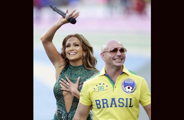 Jennifer Lopez and Rapper Pitbull greet the fans during the opening ceremony ahead of the group A World Cup soccer match between Brazil and Croatia, the opening game of the tournament, in the Itaquerao Stadium in Sao Paulo, Brazil, Thursday, June 12, 2014. (AP Photo)