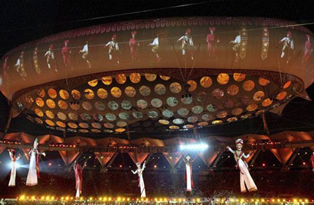 Giant puppets hang from an aerostat during the opening ceremony for the 19th Commonwealth Games at the Jawaharlal Nehru Stadium in New Delhi, India, Sunday, Oct. 3, 2010. (AP Photo)