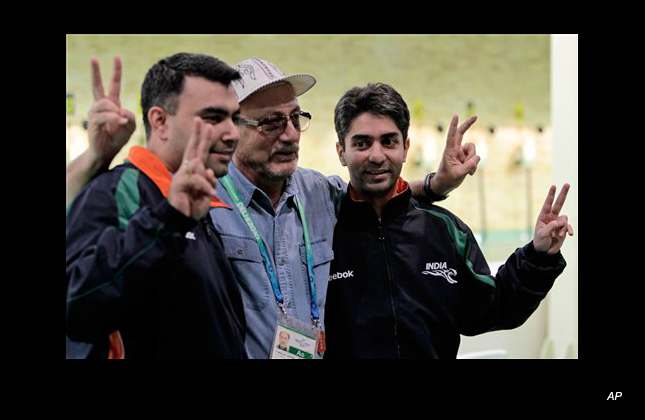 Indian shooting pair Abhinav Bindra, right, and Gagan Narang, left, show v signs with their rifle team coach Stanislav Lapidus after wining the gold medal in the 10 meter air rifle pairs event during the Commonwealth Games at the Dr. Karni Singh Shooting Range in New Delhi, India, Tuesday, Oct. 5, 2010. (AP Photo/Manish Swarup)