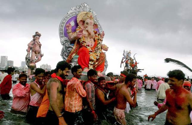 During the ten day Ganesh festival in Mumbai, devotees carry a statue of the elephant headed Hindu god into the sea.