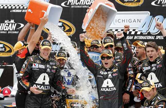 Jeff Gordon celebrates his victory with crew members after the NASCAR Sprint Cup Series Pure Michigan 400 auto race at Michigan International Speedway in Brooklyn, Mich., Sunday, Aug. 17, 2014. (AP)