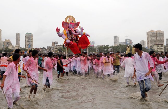 Devotees carry a large statue of Lord Ganesha to immerse it in the Arabian Sea on the final day of the festival of Ganesh Chaturthi in Mumbai. Every year millions of devout Hindus immerse Ganesh idols into oceans and rivers during the ten day long festival that celebrates the birth of Ganesha.