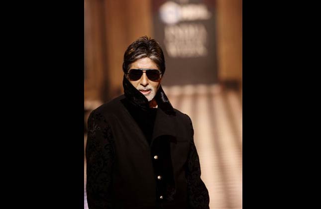 Indian actor Amitabh Bachchan showcases a creation by Indian designers Karan Johan and Varun Bahl, during the HDIL India Couture Week in Mumbai, India, Thursday, Oct. 7, 2010. (AP Photo/Rafiq Maqbool)