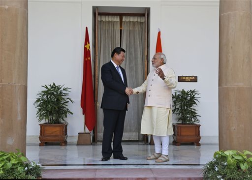 Indian Prime Minister Narendra Modi and visiting Chinese President Xi Jinping shake hands before a meeting in New Delhi, India.