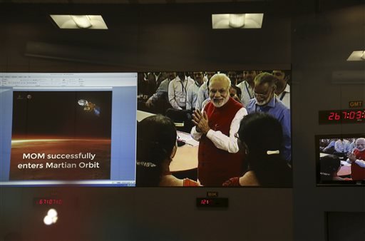 Screens show Indian Prime Minister Narendra Modi greeting Indian Space Research Organisation scientists and other officials after the success of Mars Orbiter Mission at their Telemetry, Tracking and Command Network complex in Bangalore, India, Wednesday, Sept. 24, 2014.