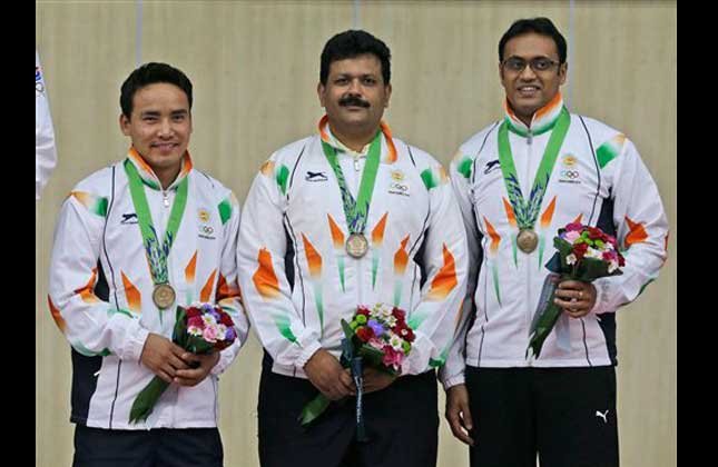 Bronze medalist, from left to right, Jitu Rai, Samaresh Jung and Prakas Papanna Nanjappa of India pose for photographers dduring the victory ceremony for the Men's 10m Air Pistol Team shooting competition at the 17th Asian Games at Ongnyeon International Shooting Range in Incheon, South Korea, Sunday, Sept. 21, 2014. (AP Photo)