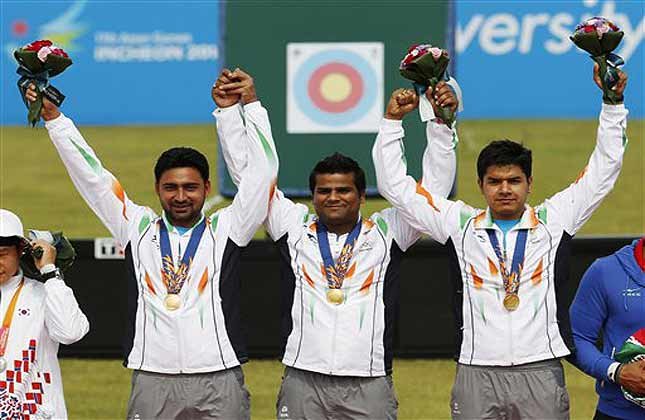 From left, gold medal winners India's team members Sandeep Kumar, Raijat Chauhan and Abhishek Verma celebrate after winning the compound men's team gold medal archery match at the 17th Asian Games in Incheon, South Korea