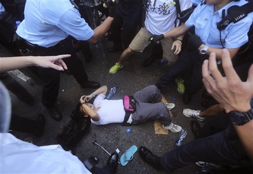 Protester falls down as they scuffle with riot policemen.