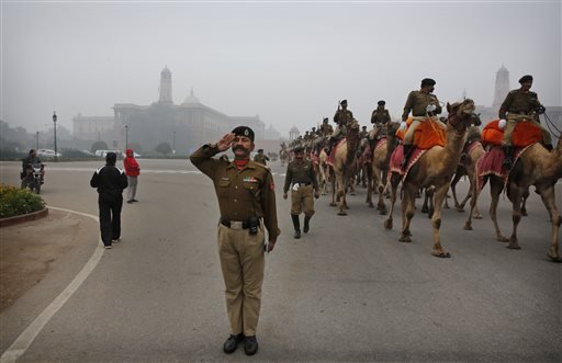 An Indian Border Security Force (BSF) soldier salutes to the marching ground as his camel mounted contingent practices a march during rehearsals for the Republic Day