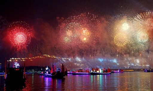 Fireworks explode over the neon lit boats on the Pear River during the opening ceremony for the 16th Asian Games in Guangzhou, China, Friday, Nov. 12, 2010.(AP Photo/Rob Griffith)