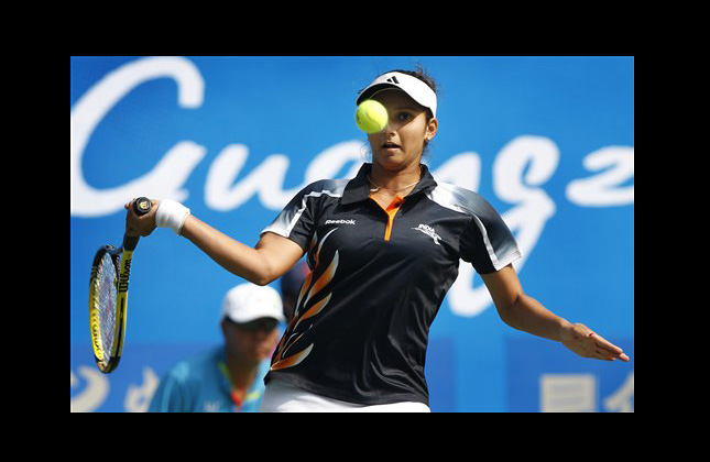 Sania Mirza of India returns a shot to Chan Wing Yau Venise of Hong Kong during the women's singles tennis event at the 16th Asian Games in Guangzhou, China, Thursday, Nov. 18, 2010. (AP Photo/Wong Maye E)