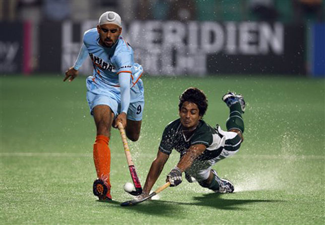 India's Gurwinder Singh Chandi, left, is challenged by Pakistan's Syed Abbas Hyder Bilgrami during the International Hockey Federation (FIH) World Cup 2010 field hockey match in New Delhi, India, Sunday, Feb. 28, 2010. (AP Photo/Saurabh Das)