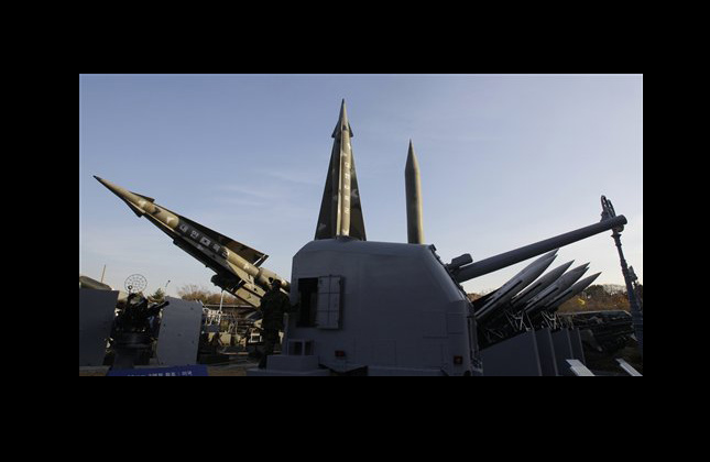 A South Korean soldier walks by displays of mock North Korea's Scud B missile, back right, and other South Korean missiles at Korea War Memorial Museum in Seoul, South Korea, Tuesday, Nov. 23, 2010. North Korea shot dozens of rounds of artillery onto a populated South Korean island near their disputed western border Tuesday, military officials said, setting buildings on fire and prompting South Korea to return fire and scramble fighter jets. (AP Photo/Lee Jin man)