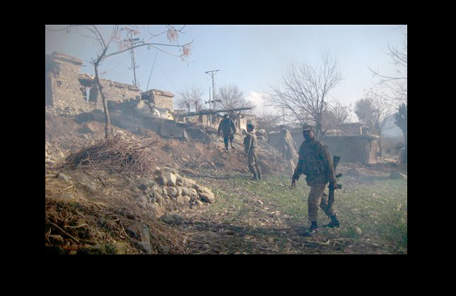 Pakistani soldiers enter a village during an operation against militants in Sewai in Pakistani tribal area of Bajur on Tuesday, Feb. 2, 2010. Pakistani troops killed eight Islamist militants Tuesday in an Afghan border region where insurgents are staging a comeback after a military operation there was declared a success, a local official said.(AP Photo/Anwarullah Khan)