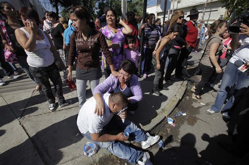 Relatives of inmates at San Miguel prison react as they wait for news after a fire killed at least 81 prisoners in Santiago, Chile, Wednesday Dec. 8, 2010. A prison fire set off during a riot killed at least 81 inmates at the Chilean prison on Wednesday and seriously injured at least 14 others, officials said. (AP Photo/Aliosha Marquez)