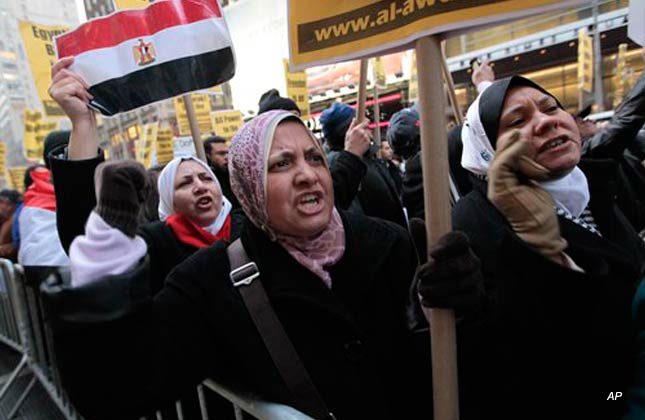 Protestors chant slogans during a demonstration in Times Square against Egyptian President Hosni Mubarak Friday, Feb. 4, 2011 in New York. (AP Photo/Mary Altaffer)