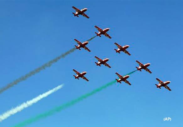 Indian air force aircraft perform aerobatic flight at the opening ceremony of Aero India 2011 in Yelahanka air base on the outskirts of Bangalore, India, Wednesday, Feb. 9, 2011. More than 300 weapon makers are participating in in the five day event in hopes of capturing a share of $10 billion worth of fighter jets and other arms India is planning to buy from overseas. (AP Photo/Aijaz Rahi)