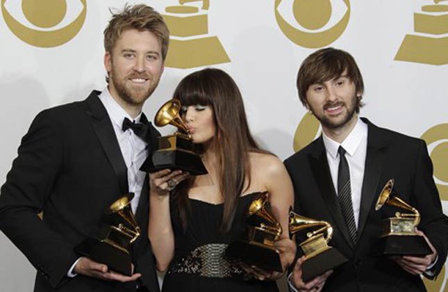 Lady Antebellum, from left, Charles Kelley, Hillary Scott and Dave Haywood pose backstage with the award for best record of the year at the 53rd annual Grammy Awards on Sunday, Feb. 13, 2011, in Los Angeles. (AP Photo/Jae C. Hong)