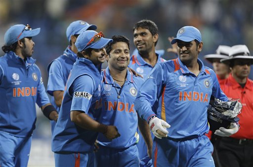 Indian cricket captain Mahendra Singh Dhoni, right, with teammates celebrate their win over Australia in a warm up match of International Cricket Council (ICC) Cricket World Cup in Bangalore, India, Sunday, Feb. 13, 2011. (AP Photo/Aijaz Rahi)