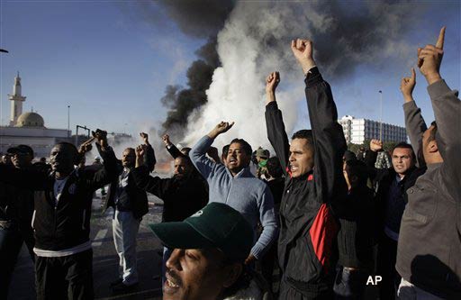 Pro Gadhafi supporters chant in support of the Libyan Leader at the scene of a fuel tanker explosion, which security forces at the scene said was due to a road accident, in Tripoli, Libya, Wednesday, March 2, 2011. (AP Photo/Ben Curtis)