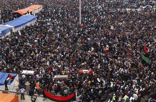 Libyan mourners carry the coffins of three protesters who were killed the previous week in demonstrations against Libyan leader Moammar Gadhafi, in Benghazi, Libya. (AP Photo/Hussein Malla, File)