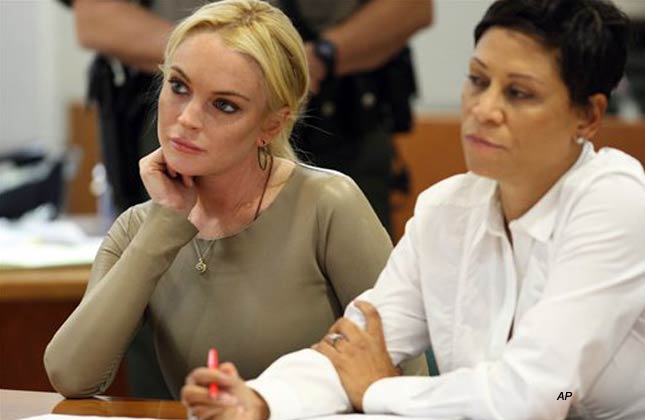 Lindsay Lohan is seen with her attorney, Shawn Chapman Holley at Los Angeles Superior Court, Thursday, March 10, 2011. Lohan rejected a plea agreement Thursday offered by prosecutors in a grand theft case that included a guaranteed return to jail. She told a judge she agreed to delaying her case until a preliminary hearing when prosecutors will present evidence against her. Lohan is accused of taking a $2,500 necklace from a Venice jewelry store. (AP Photo/David McNew, pool)