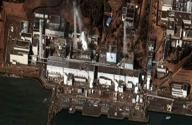 This satellite photo taken Wednesday March 16, 2011 and provided by DigitalGlobe shows the damage after an earthquake and tsunami at the Fukushima Dai ichi nuclear power plant complex. The satellite image confirms damage to the Units 1, 3, and 4 reactor buildings. Steam can be seen venting from the unit 2 reactor building, as well as from the Unit 3 reactor building. Additional damage can be seen to several other buildings approximately 350 meters north of the Unit 2 reactor building. (AP Photo/DigitalGlobe)