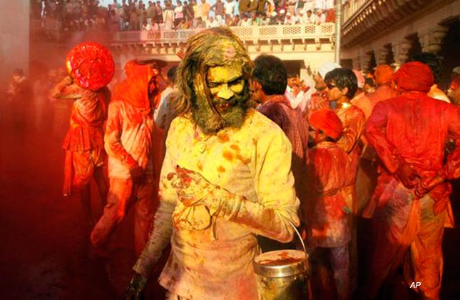 Indian villagers smear themselves with colors as they celebrate Holi festival in Nandgaon, near Mathura, India, Tuesday, March 15, 2011. (AP Photo/Pankaj Nangia)