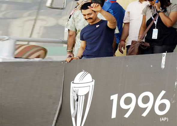 Bollywood actor Aamir Khan waves to fans prior to the start of the Cricket World Cup semifinal match between Pakistan and India in Mohali, India, Wednesday, March 30, 2011. (AP Photo/Gurinder Osan)