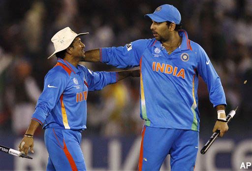 India's Sachin Tendulkar, left, and Yuvraj Singh celebrate their win over Pakistan by 29 runs in the Cricket World Cup semifinal match in Mohali, India, Wednesday, March 30, 2011. (AP Photo/Aijaz Rahi)