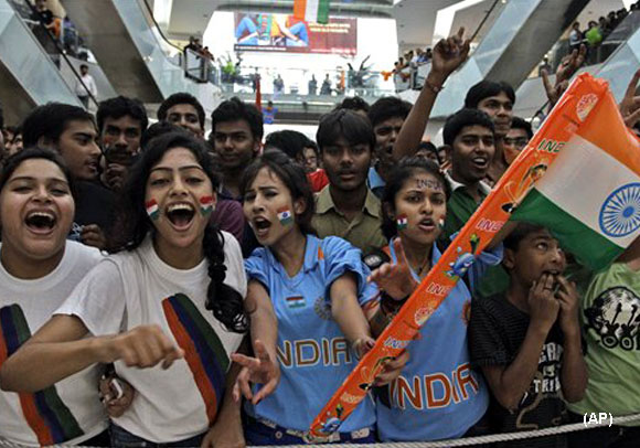 Indian cricket fans cheer for their team as they watch the World Cup cricket final match between India and Sri Lanka, at a mall in Kolkata, India, Saturday, April 2, 2011. (AP Photo/Bikas Das)